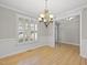 Elegant dining room featuring hardwood floors and a stylish chandelier at 2721 Cameron Pond Dr, Cary, NC 27519