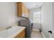 Bright laundry room featuring modern appliances and storage cabinets at 2721 Cameron Pond Dr, Cary, NC 27519