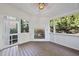 Inviting sunroom features a fireplace, wood floors, an abundance of windows, and natural light at 2721 Cameron Pond Dr, Cary, NC 27519