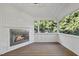 Inviting sunroom features a fireplace, wood floors, an abundance of windows, and natural light at 2721 Cameron Pond Dr, Cary, NC 27519