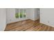 Bedroom features neutral walls, large window and new floors at 2821 Edridge Ct, Raleigh, NC 27612