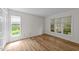 Bright bedroom features two windows, neutral walls and new floors at 2821 Edridge Ct, Raleigh, NC 27612