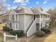 Inviting two-story home with exterior stairs, mature landscaping, and light gray siding at 2821 Edridge Ct, Raleigh, NC 27612