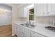 Bright kitchen features a stainless steel sink, white cabinets, and plenty of natural light at 2821 Edridge Ct, Raleigh, NC 27612