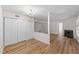 Spacious living room featuring laminate flooring, a fireplace, and ample closet space at 2821 Edridge Ct, Raleigh, NC 27612