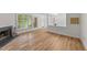 Open living room features a fireplace, new floors and plenty of natural light at 2821 Edridge Ct, Raleigh, NC 27612