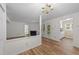 Bright living room with laminate flooring, a fireplace, and access to the kitchen at 2821 Edridge Ct, Raleigh, NC 27612