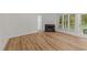 Bright living room features a fireplace, laminated flooring, and plenty of natural light at 2821 Edridge Ct, Raleigh, NC 27612