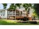 Home's backyard featuring a screened-in porch and deck. Well-maintained lawn and landscaping at 303 Middleham Dr, Rolesville, NC 27571