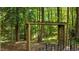 A charming wooden pergola nestled among the lush trees of this home's backyard at 303 Middleham Dr, Rolesville, NC 27571