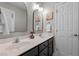 Bathroom with dual sinks, a large mirror, and modern fixtures, neutral paint and decor at 303 Middleham Dr, Rolesville, NC 27571