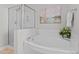 Bathroom features a separate glass-enclosed shower and a large soaking tub at 303 Middleham Dr, Rolesville, NC 27571