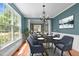 Formal dining room with hardwood floors, chandelier, large windows, and ample natural light at 303 Middleham Dr, Rolesville, NC 27571
