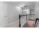 Bright hallway with neutral walls, carpet, and wooden banister providing an open view to the floor below at 303 Middleham Dr, Rolesville, NC 27571