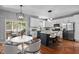 Bright kitchen with white cabinets, stainless steel appliances, large island, and modern lighting at 303 Middleham Dr, Rolesville, NC 27571