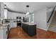 Bright kitchen with white cabinets, stainless steel appliances, large island, and modern lighting at 303 Middleham Dr, Rolesville, NC 27571