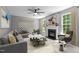 Bright living room featuring fireplace, ceiling fan, decor, and comfortable seating at 303 Middleham Dr, Rolesville, NC 27571
