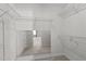 Spacious walk-in closet featuring ample storage with adjustable shelves and a mirror showcasing the view into the bedroom at 303 Middleham Dr, Rolesville, NC 27571