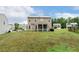View of backyard with porch and the back of a two story house at 307 W Copenhaver Dr, Clayton, NC 27527