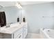 Bathroom with dual sinks, vanity, and a bathtub at 307 W Copenhaver Dr, Clayton, NC 27527