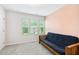 Bedroom with a blue futon and a window view to the outside at 307 W Copenhaver Dr, Clayton, NC 27527