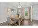 Dining room featuring hardwood floors, modern chandelier, seating for six, and a window that lets in lots of light at 307 W Copenhaver Dr, Clayton, NC 27527
