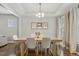Dining room with modern chandelier, seating for six, and a window that lets in lots of natural light at 307 W Copenhaver Dr, Clayton, NC 27527