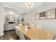 Open-concept dining room boasts hardwood floors, a modern chandelier, and easy access to the living room at 307 W Copenhaver Dr, Clayton, NC 27527