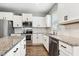 Kitchen features stainless steel appliances, granite countertops, white subway tile backsplash, and hardwood floors at 307 W Copenhaver Dr, Clayton, NC 27527