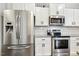 Close up of kitchen featuring stainless steel appliances, granite countertops and white subway tile backsplash at 307 W Copenhaver Dr, Clayton, NC 27527