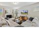 Spacious living room with comfortable seating, a fireplace, and a large screen television at 307 W Copenhaver Dr, Clayton, NC 27527