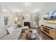 Bright living room featuring a fireplace, large sectional sofa, and modern entertainment center at 307 W Copenhaver Dr, Clayton, NC 27527
