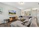 Open concept living room with a fireplace, large sectional couch, and backyard views at 307 W Copenhaver Dr, Clayton, NC 27527