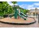 A green playground structure features slides and climbing areas in a community recreation space at 307 W Copenhaver Dr, Clayton, NC 27527