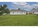 Expansive backyard provides ample green space with a view of the rear of the home and surrounding landscape at 308 Sandy Knob Ln, Rocky Mount, NC 27803