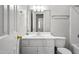 Well-lit bathroom with a single sink vanity, a large mirror, and neutral walls at 308 Sandy Knob Ln, Rocky Mount, NC 27803
