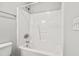Clean white bathroom featuring a tub and shower with white tile surround at 308 Sandy Knob Ln, Rocky Mount, NC 27803