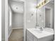 Well-lit bathroom with a white vanity, modern fixtures, and a glimpse into an adjacent room at 308 Sandy Knob Ln, Rocky Mount, NC 27803