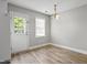 Bright dining area featuring wood-look flooring, a window, and a classic chandelier at 308 Sandy Knob Ln, Rocky Mount, NC 27803