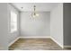 A dining area with wood-look flooring, soft gray walls, and a decorative chandelier at 308 Sandy Knob Ln, Rocky Mount, NC 27803