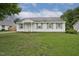 Charming single-story home features a well-manicured lawn and classic architectural details under a bright sky at 308 Sandy Knob Ln, Rocky Mount, NC 27803