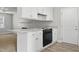 Stylish kitchen featuring granite countertops, stainless steel appliances, and white cabinets for a modern look at 308 Sandy Knob Ln, Rocky Mount, NC 27803