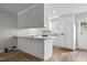 Modern kitchen with sleek breakfast bar, white cabinetry, and wood-look flooring, flooded with natural light at 308 Sandy Knob Ln, Rocky Mount, NC 27803