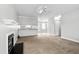 Open-concept living area boasts neutral tones, fireplace, and seamless transition to the kitchen at 308 Sandy Knob Ln, Rocky Mount, NC 27803