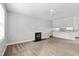 Bright living room with cozy fireplace, neutral carpet, and an open view into the adjacent kitchen area at 308 Sandy Knob Ln, Rocky Mount, NC 27803