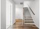 Bright entryway featuring hardwood floors, stairs, and white trim at 3101 Brellon Ln, Durham, NC 27703