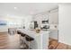 A modern kitchen featuring a large island with seating, stainless steel appliances, and open access to the dining area at 3101 Brellon Ln, Durham, NC 27703