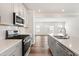 An open concept kitchen with stainless appliances, quartz countertops, subway tile backsplash, and eat-in dining at 3101 Brellon Ln, Durham, NC 27703