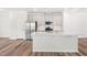 Bright, open kitchen featuring a spacious island, stainless steel appliances, and seamless flow to the dining area at 3101 Brellon Ln, Durham, NC 27703