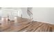 Bright open-concept living area featuring wood floors and a stairway leading up to the second story at 3101 Brellon Ln, Durham, NC 27703